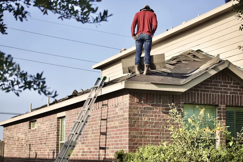 Professional roofer working on a residential roof in Upper Mount Bethel